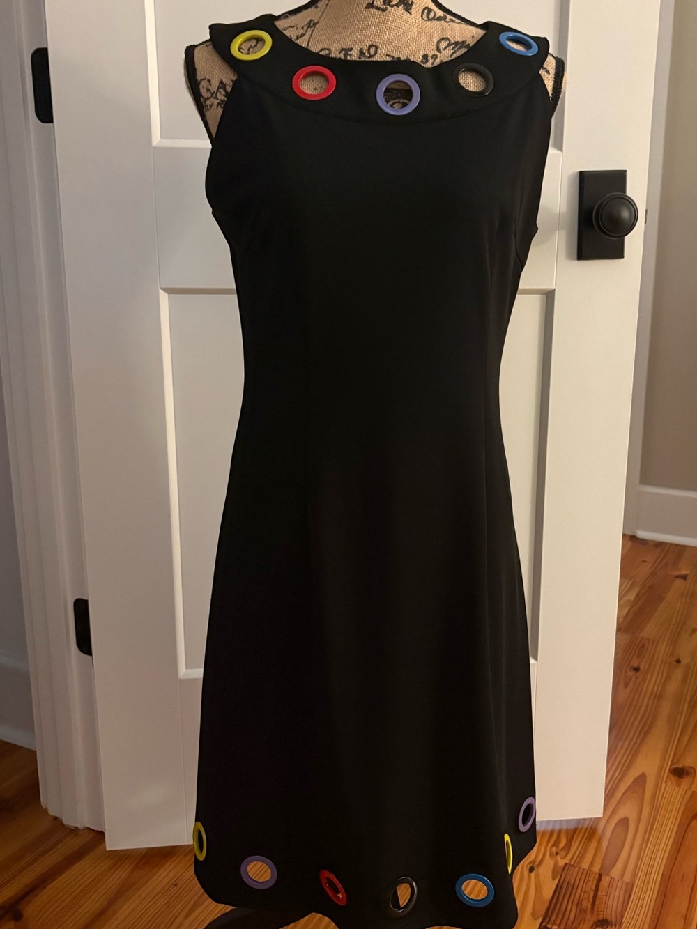 Classic Black Sleeveless A-Line Dress with colorful grommet accents